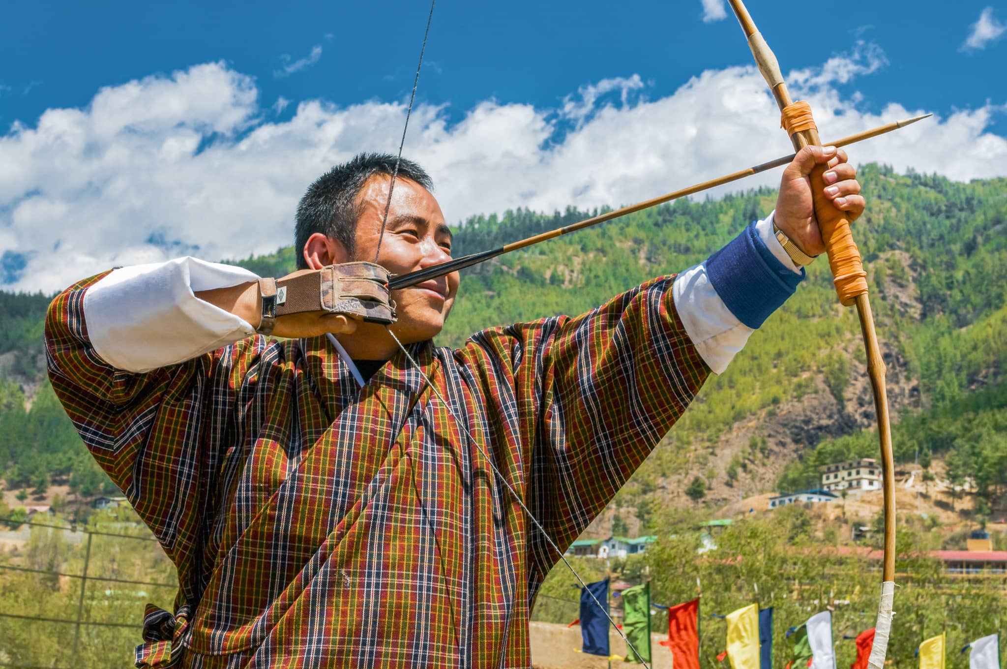 Traditional Bhutanese man practicing archery, Bhutan