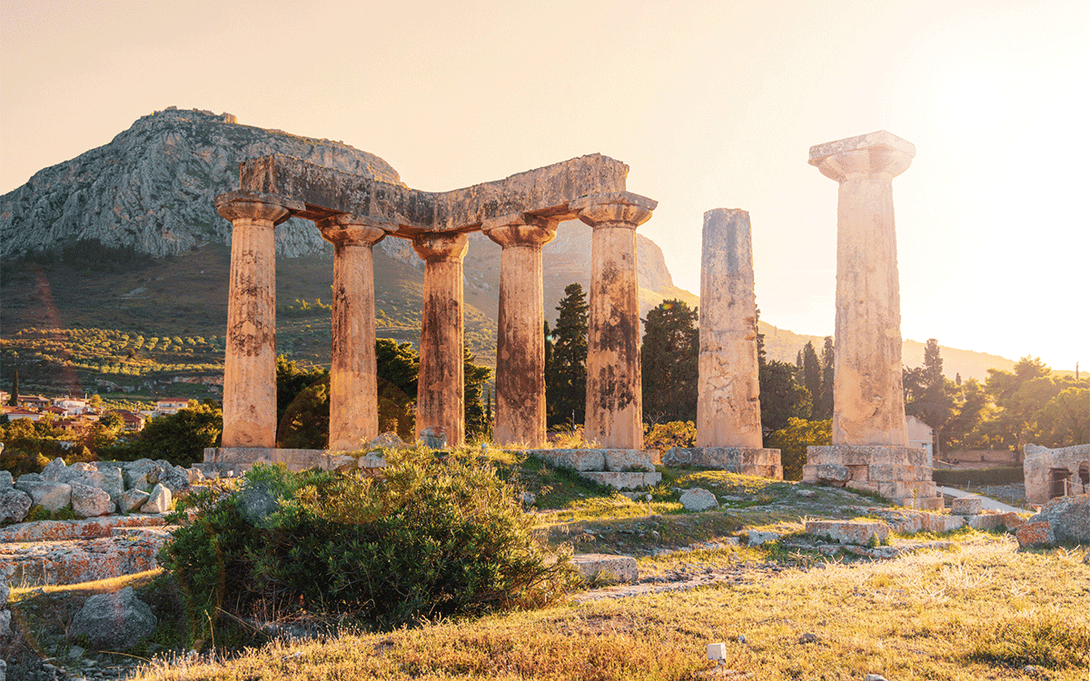 Ruins of temple of Apollo at sunset, Ancient Corinth in Greece