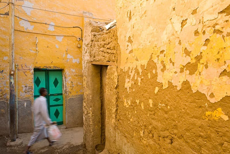 egypt nubian village man walking yellow house